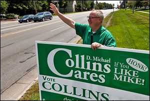 Mayoral candidate D. Michael Collins campaigns at Reynolds Road and Airport Highway.