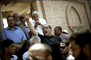 A friend of Ammar Badie shouts, ‘Allah is the greatest,' while attending Mr. Badie’s burial Sunday. Mr. Badie, 38, the son of the Muslim Brotherhood’s spiritual leader, was killed Friday by security forces in Cairo.