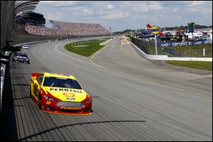 Joey Logano holds a lead in to turn one during the Pure Michigan 400 on Sunday at Michigan International Speedway. He went on to win the race.