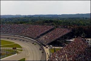 Cars make their way into turn one during the Pure Michigan 400.