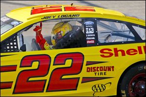 Joey Logano holds up his finger to signal he’s No. 1 after taking the checkered flag at the Pure Michigan 400 on Sunday.
