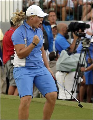 Europe's Caroline Hedwall celebrates after making a birdie putt on the 18th hole to give her the win over American Michelle Wie during the singles matches at the Solheim Cup on Sunday in Parker, Colo. The win gave Europe 14 points as they retained the Solheim Cup.
