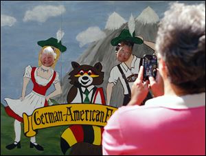 Kay Drill, left, and Denise Schick, right, both of Oregon, get their picture taken by Janet Tutera of Marblehead, durin the 2012 German-American Festival in Oregon.