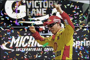 Joey Logano celebrates his NASCAR Sprint Cup Series win Sunday in the Pure Michigan 400 at Michigan International Speedway in Brooklyn. That boosted his chances of making the Chase.