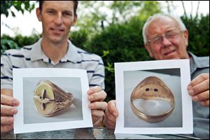 Martin Kiss, right, and his U.S. neighbor Mark Turner hold photos of a golden ring which Kiss received from his grandparents, in Herrieden, southern Germany.