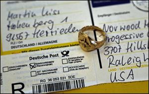 A gold aviator's ring that belonged to U.S. Army Air Corps 2nd Lt. David C. Cox during World War II rests on a freshly opened package from Germany.