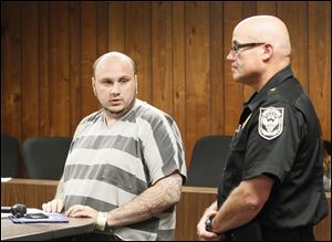 Joshua Michael Greenhill, left, during his arraignment. At right is Dundee police chief David Uhl.
