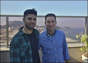 In this undated photo released by Janine Gibson of The Guardian, Guardian journalist Glenn Greenwald, right, and his partner David Miranda.