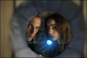 Jamie Campbell Bower as Jace, left, and Lily Collins as Clary in a scene from 'The Mortal Instruments: City of Bones.' 