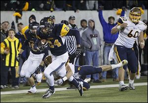 Whitmer's Marcus Elliott runs for a touchdown after recovering a fumble by Cincinnati Moeller in the Division I state championship last season.