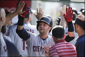 Cleveland Indians' Nick Swisher, center, is greeted by teammates after hitting a two-run home run during the third inning of a baseball game against the Los Angeles Angels on Wednesday, Aug. 21, 2013, in Anaheim, Calif. (AP Photo/Jae C Hong)
