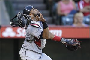 Cleveland Indians catcher Carlos Santana looks to field a bunt by Los Angeles Angels' J.B. Shuck during the seventh inning of a baseball game Wednesday, Aug. 21, 2013, in Anaheim, Calif. Shuck was out at first. (AP Photo/Jae C Hong)