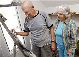  Inge Lanzenberger watches husband, Herman, who has multiple myeloma, paint at their Perrysburg home. Multiple myeloma is a type of blood cancer that affects certain cells in the bone marrow.