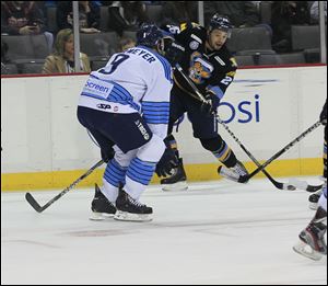 Walleye forward Stephon Thorne prepares to shoot past Icemen defender Jake Obermeyer in a Jan. 27 game at the Huntington Center.