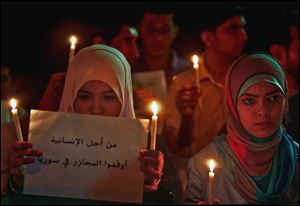 Palestinians in Gaza City protest the Syrian regime and condemn the alleged poison gas attack on the suburbs of Damascus.