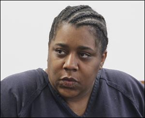 Kenya McGhee, 38, appears before Lucas County district judge Dean Mandros on charges of aggravated murder and arson for setting a March 25, 2012 fire at a Springfield Township condominium complex. 