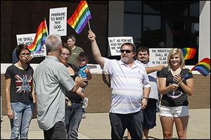 The Owens Community College Gay Straight Alliance marches in the annual Toledo Pride parade on Saturday. In its fourth year, the parade has become a major downtown event. 