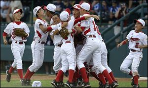 Japan celebrates after its ninth Little League World Series title, a 6-4 win over Chula Vista, Calif.