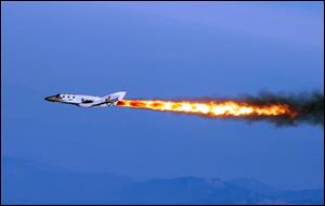 Virgin Galactic, the company’s SpaceShipTwo fires its rockets over Mojave, Calif., after it was dropped from its 