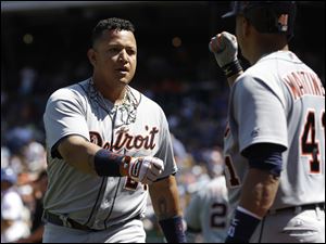 The Tigers' Miguel Cabrera, left, celebrates his two-run home run with teammate Victor Martinez during the first inning Sunday in New York. Cabrera’s two-run drive was his 42nd long ball of the season and 10th in 19 games. He went 3 for 4 with a walk, raising his batting average to a major league-best .360, and finished the series 7 for 13 with two homers and five RBIs.