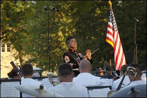 Marine Master Sgt. William Call leads the Navy Band Great Lakes Wind Ensemble and Marine Corps Band New Orleans during a joint concert in Perrysburg. On Labor Day at 1 p.m. the Navy Band Great Lakes Wind Ensemble will be in concert at the Commodore Schoolyard after performing at three area locations.
