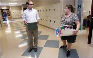 Bill Byrnes, science and social studies teacher, and Sharon Clark, English and language arts teacher, chat in a hallway of the new wing as they prepare for the first day of school today at Whittier.