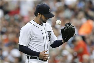 Detroit Tigers pitcher Anibal Sanchez tosses the ball against the Oakland Athletics in the first inning of a baseball game in Detroit, Monday, Aug. 26, 2013. (AP Photo/Paul Sancya)