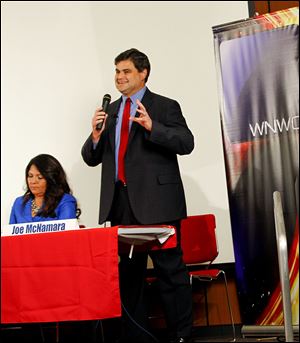 Joe McNamara speaks as Anita Lopez listens during a mayoral candidate forum sponsored by WNWO, Channel 24 at the downtown Toledo-Lucas County Public Library.