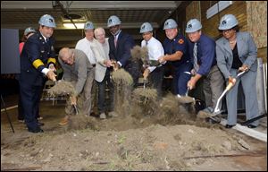 From left, Toledo Fire Department Chief Luis Santiago; former chief Bill Winkle; city councilman Rob Ludeman; former fire chief Carl Neeb; Mayor Mike Bell; Fire Captain Dennis Marzec; Fire Capt. Jeff Romstadt;  and Deputy Mayor Shirley Green shovel dirt during a ground breaking for the reconstruction of Fire Station No. 3.