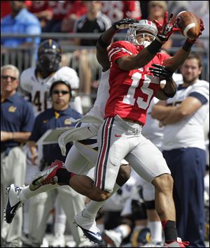 Ohio State's Devin Smith makes a catch against California's Steve Williams. Smith had 30 receptions for 618 yards and six touchdowns last season.