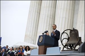 President Obama gestures while speaking during a ceremony commemorating the 50th anniversary of the March on Washington at the Lincoln Memorial.