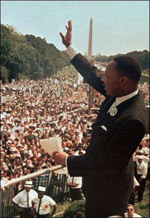 The Rev. Martin Luther King Jr. waves to the crowd at the Lincoln Memorial on Aug. 28, 1963.