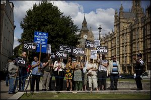 People take part in a protest calling for no military attack on Syria from the U.S., Britain or France, outside the Houses of Parliament, in London, organized by the Stop the War coalition.