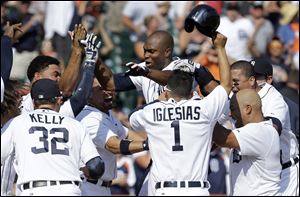Detroit Tigers' Torii Hunter, top center celebrates with teammates hitting a three-run walk off home run to beat the Oakland Athletics 7-6 today in Detroit.