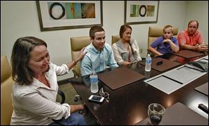 The Fudacz family — from left, mom Ellen, Paul, Jr., Sarah, Joseph, and dad Paul, Sr. — discuss the painful events of the last year in the law offices of James E. Arnold & Associates in Columbus.