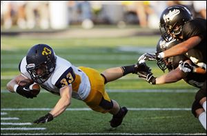 Whitmer running back Zac Ryan dives for extra yardage against Perrysburg. He ran 17 times for 69 yards and one touchdown.