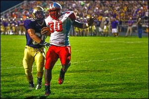 Bowsher's Mark Washington scores against Maumee's Dakota Yeary. Washington rushed for 117 yards on 13 carries and scored three touchdowns.