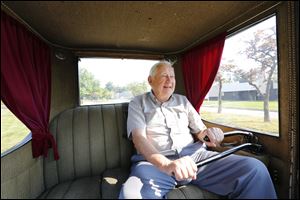 Ford Cauffiel drives his1917 Milburn Light Electric with two tillers instead of a steering wheel and accelerator.