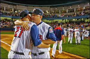 Toledo Mud Hens manager Phil Nevin gets a hug from player Kenny Faulk (27) after the Hens defeat teh Columbus Clippers at Fifth Third Field, Saturday, August 31, 2013.