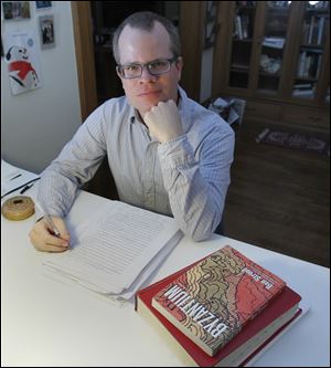 Author and University of Toledo creative writing professor Ben Stroud in his Old West End home in Toledo. He's currently working on a new novel, and his collection of short stories is at right.