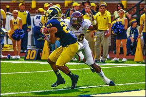 Michigan's Jeremy Gallon catches a touchdown pass against Central Michigan's Dennis Nalor in Saturday's game. 