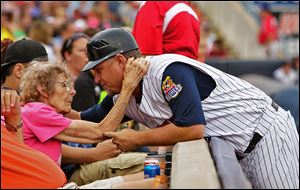Phil Nevin gets a hug from Toledo Mud Hens’ season ticket holder Beulah Remy of Toledo.