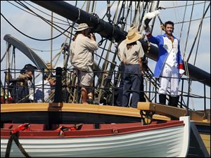 Actor Billy Campbell, portraying Comm. Oliver Hazard Perry, waves from the Brig Niagara during Monday’s re-enactment, complete with 15 tall ships. 
