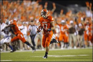 Bowling Green State University player Ryan Burbrink (17) runs back a punt for a touchdown during the fourth quarter.