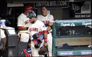 Cleveland Indians catcher Carlos Santana, front left, walks past Asdrubal Cabrera, back right, on his way to the clubhouse after a 7-2 loss.