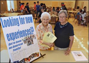 During an International Friendship Program meeting at Bowling Green State University, Phyllis Oster, left, and Dawn McCaghy sign up foreign BGSU students who want to be involved with American families as hosts.