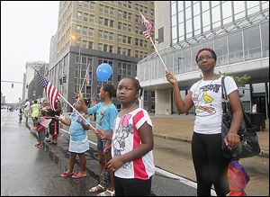 Natasha Blackmon, right, of Toledo; daughter, Iyanna Scrutchins, 7, and nieces Jala Brazzil, 11, and Sonee Brazzil, 8, watch the parade.