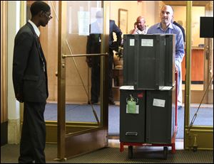 Ballots are rolled in for re-examination at Cadillac Place in Detroit. The final, official results were delayed because city elections workers used numeric counts instead of the preferred hash marks in their tally.