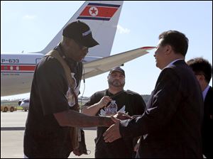Former NBA star Dennis Rodman, left, is greeted by Son Kwang Ho, vice-chairman of North Korea's Olympic Committee, at Pyongyang airport, North Korea, today.