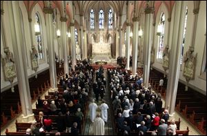 The clergy and family process into the church during the memorial service for former Ohio Gov. John Joyce 
